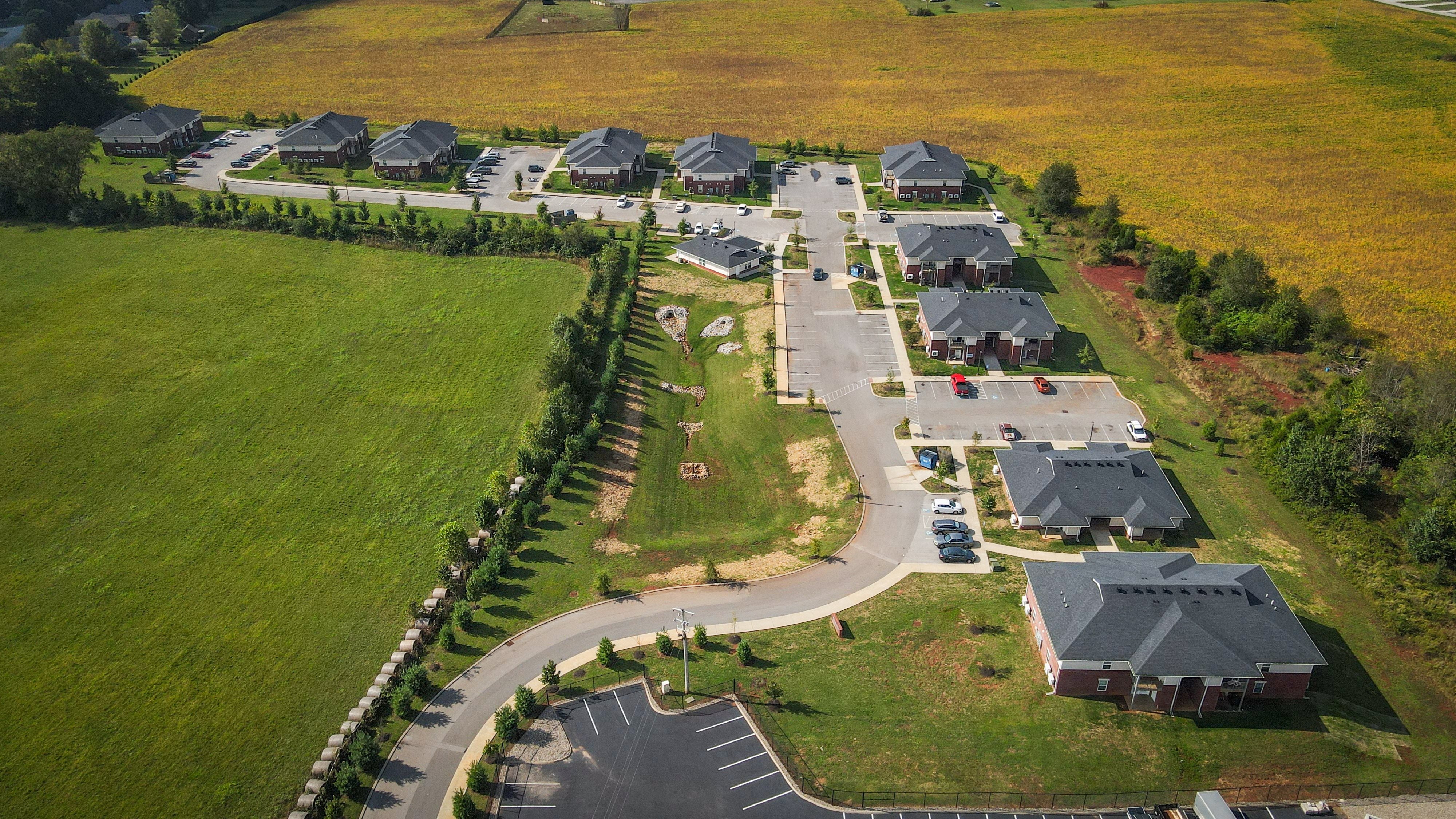 an aerial view of a neighborhood of houses on a street